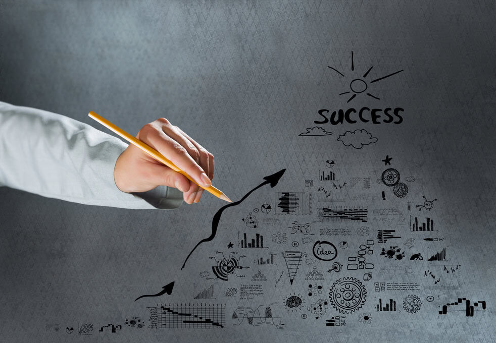 Close up of hand drawing business sketches on cement wall